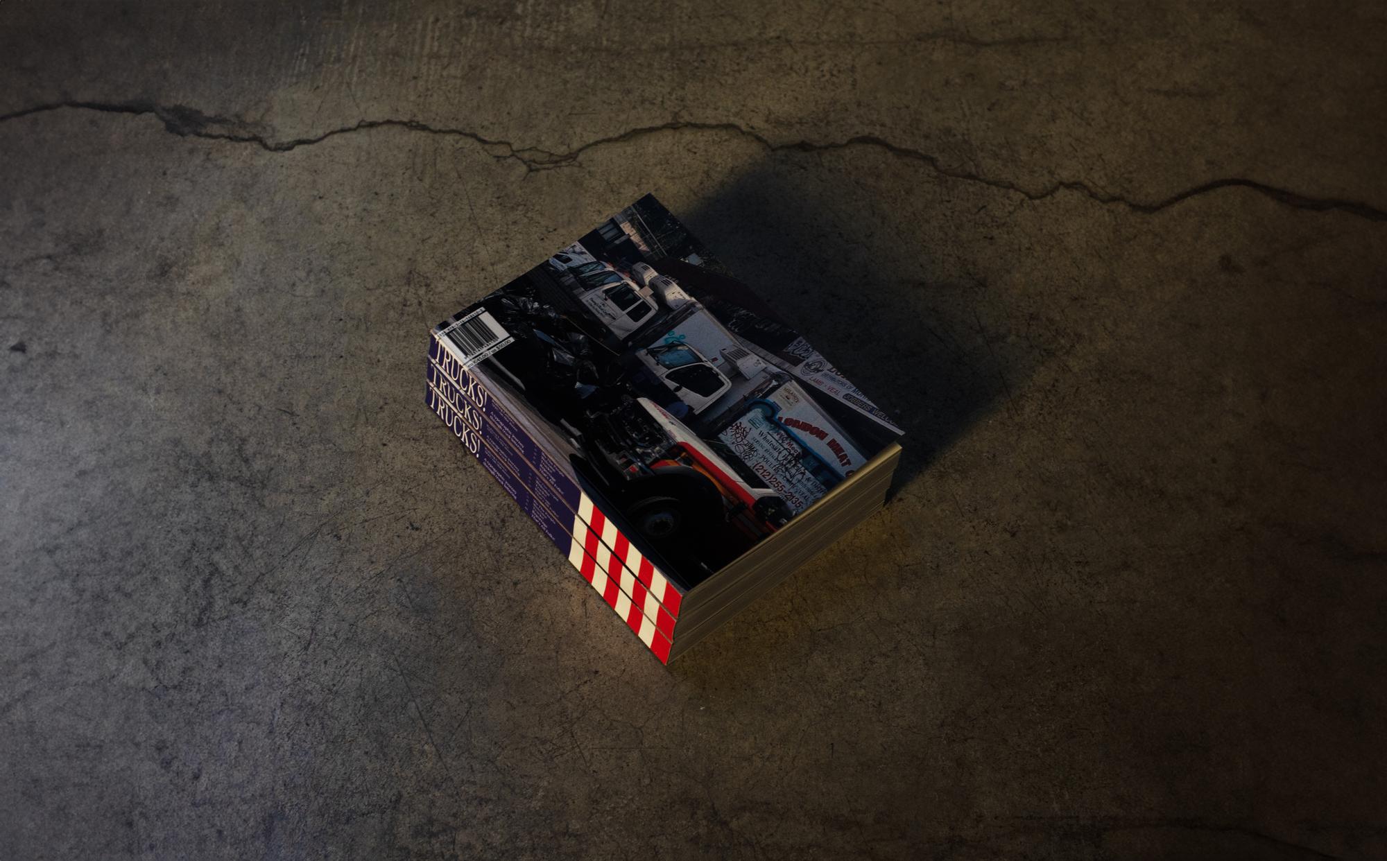 Trucks! book, still life on concrete